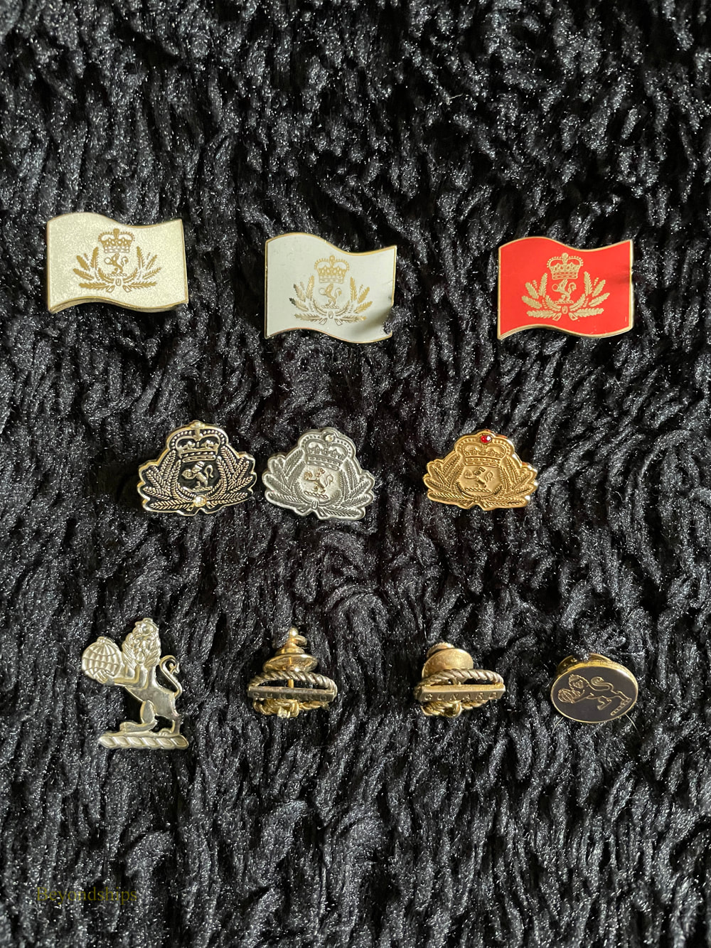 A collection of pins issued by Cunard Line 