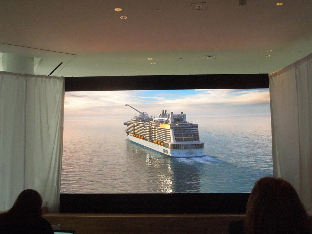 Audience members watch a video of Quantum of the Seas
